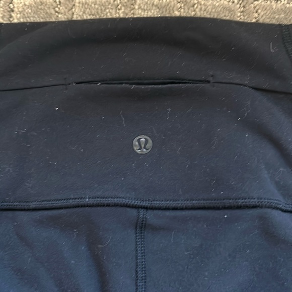 Black Lululemon leggings with lace on the side. Back and side pockets - Picture 3 of 3